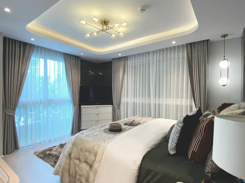 A furnished bedroom with circulation space in the Pristine Park III show unit, Pattaya