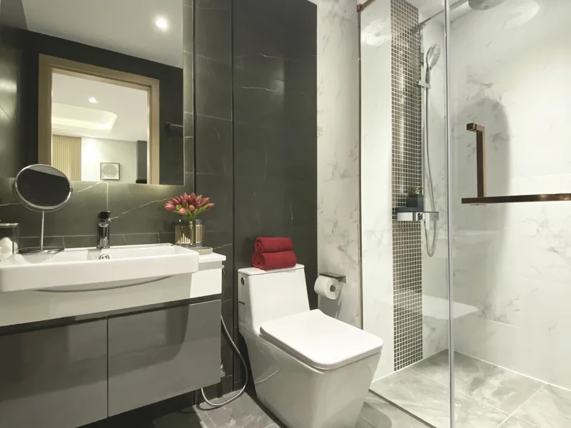 A bathroom with washbasin, toilet and shower in the Pristine Park III show unit, Pattaya